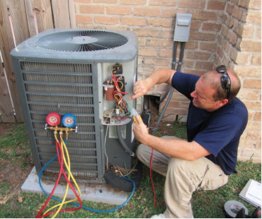 HVAC service professional assessing and fixing problems with a failed exterior unit. 