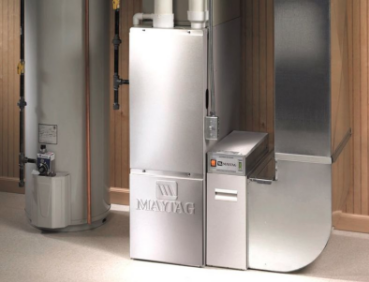 A high efficiency furnace located in the basement of a residential home, made by Maytag.